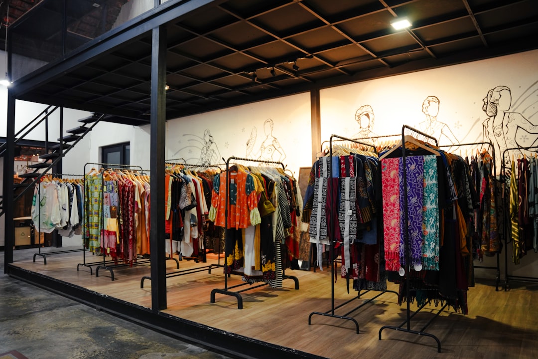 Interior of a modern boutique showcasing traditional and contemporary clothing on racks, blending cultural fashion with a stylish retail space.